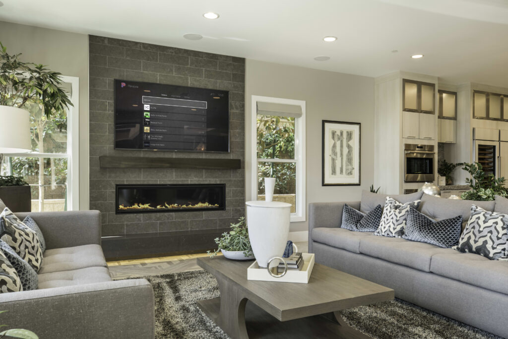 Wall-mounted television with concealed wiring above a fireplace