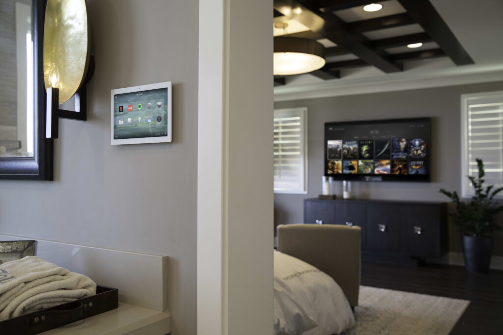 Control4 touch panel controlling lighting and audio in a living room