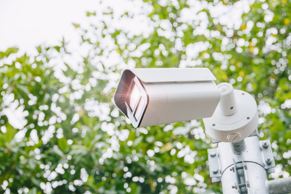 Technician installing a PoE security camera on a rural Caledon property
